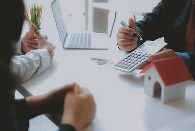 Couple discussing finances with a broker