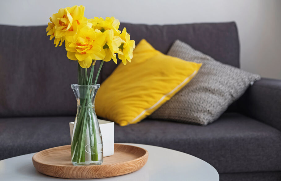 A vase of daffodils on a table