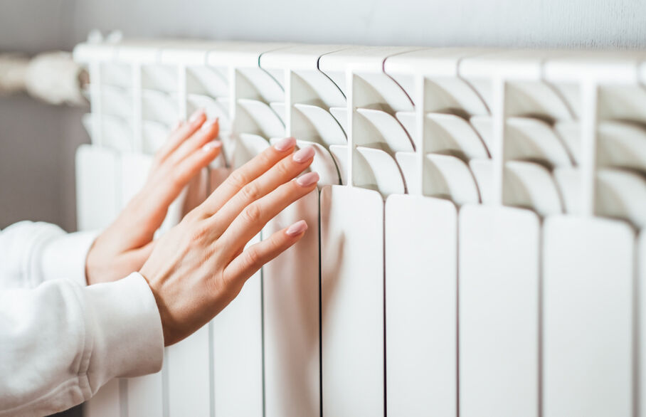 Someone warming their hands on a radiator