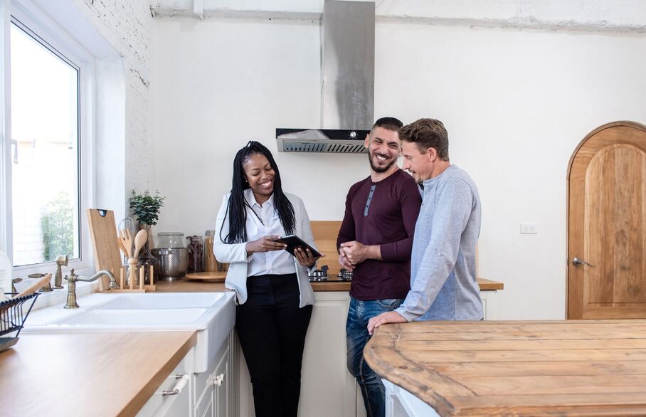 An estate agent showing a couple around a house