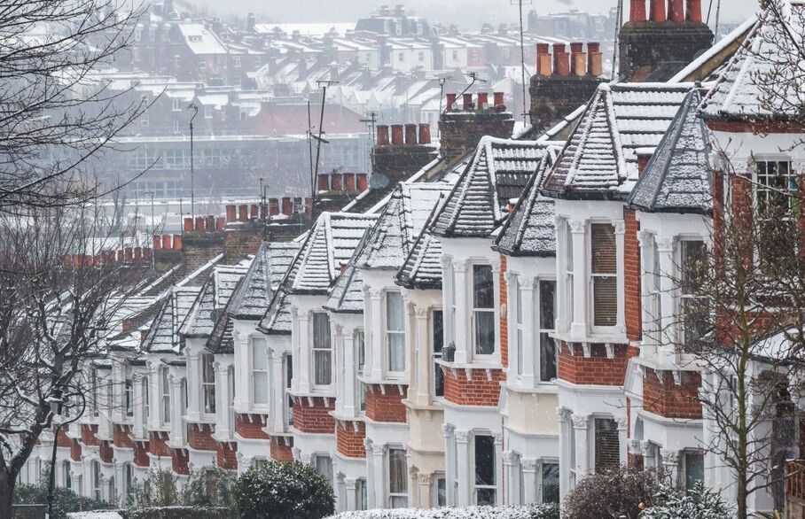 A row of houses covered in snow