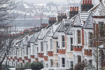 A row of houses covered in snow