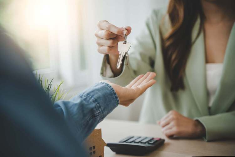 Two people exchange a set of keys