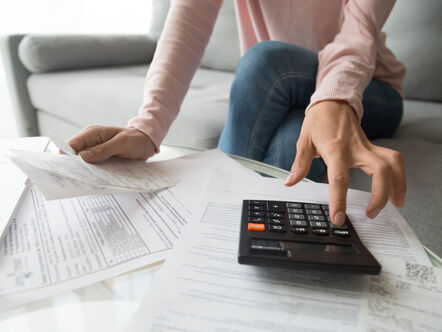 Lady with paperwork and calculator