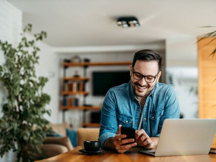 Man on a laptop and phone 