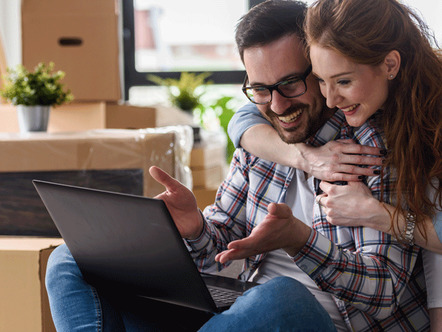 Young couple moving in new home. Sitting and relaxing after unpacking