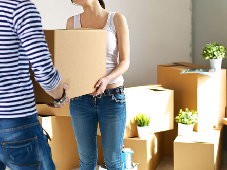 Happy young couple packing boxes